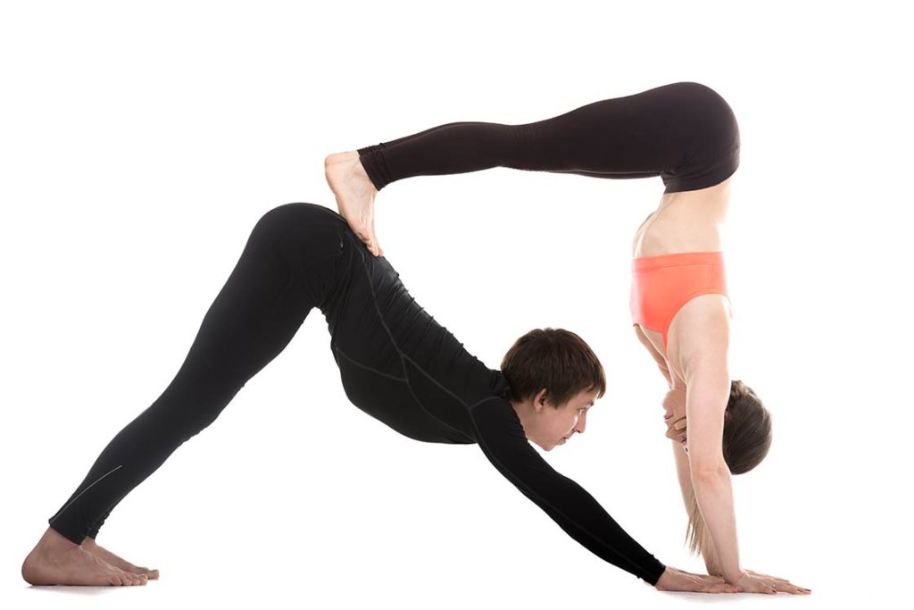 Professional partner yoga poses photos showing advanced practitioners in challenging, visually impressive poses
