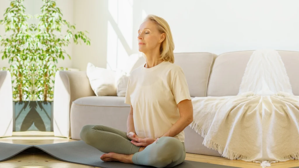 beginner woman meditating on yoga mat indoors, peaceful meditation practice for beginners